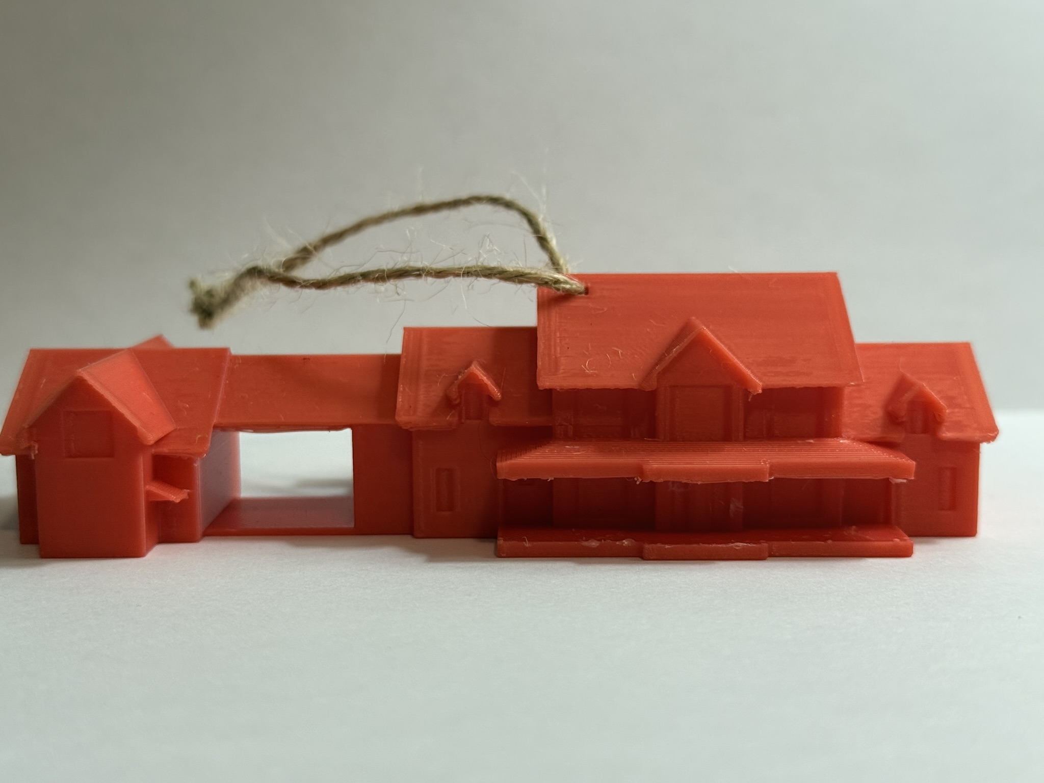 Photograph of the finished 3D-printed residential model on a display base
